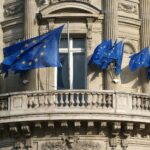 european union flags on building by David Mark