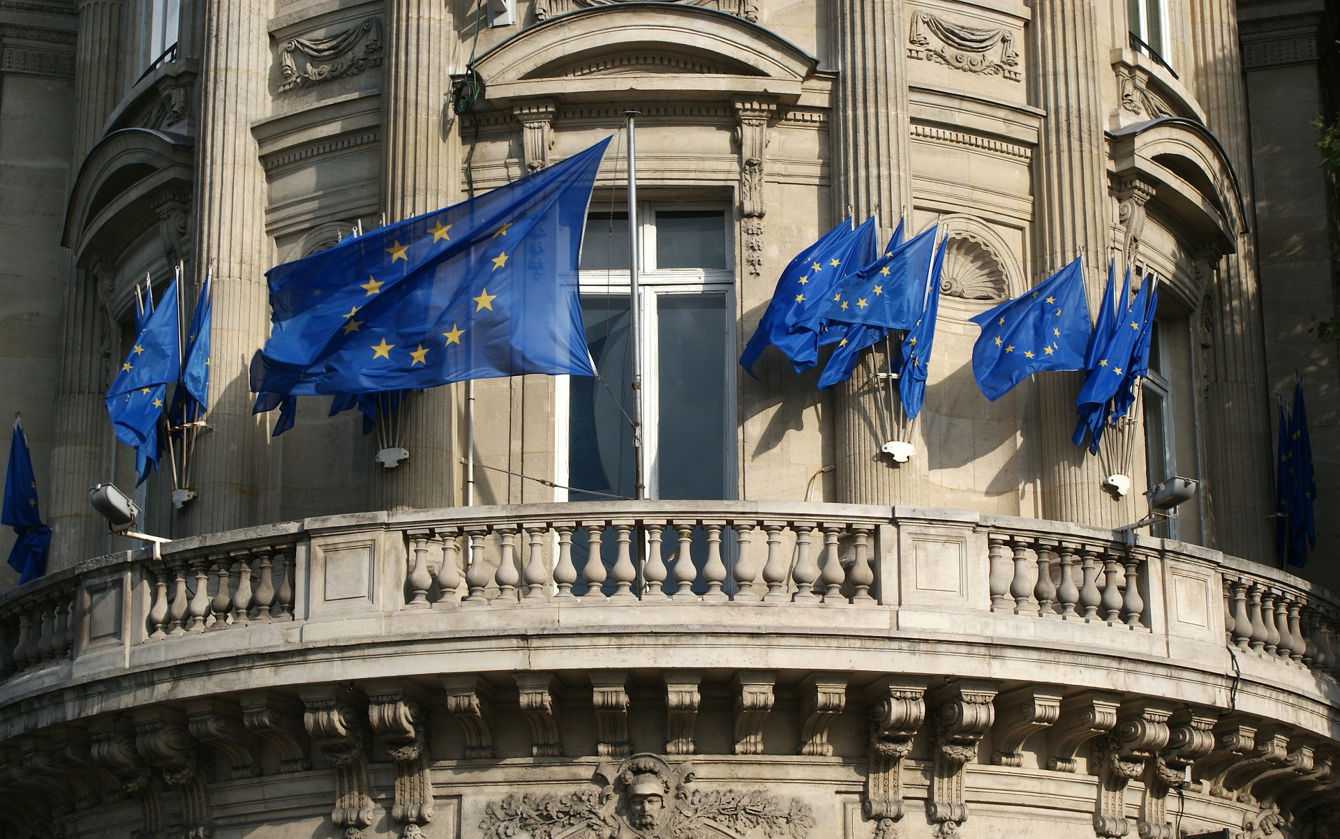 european union flags on building by David Mark